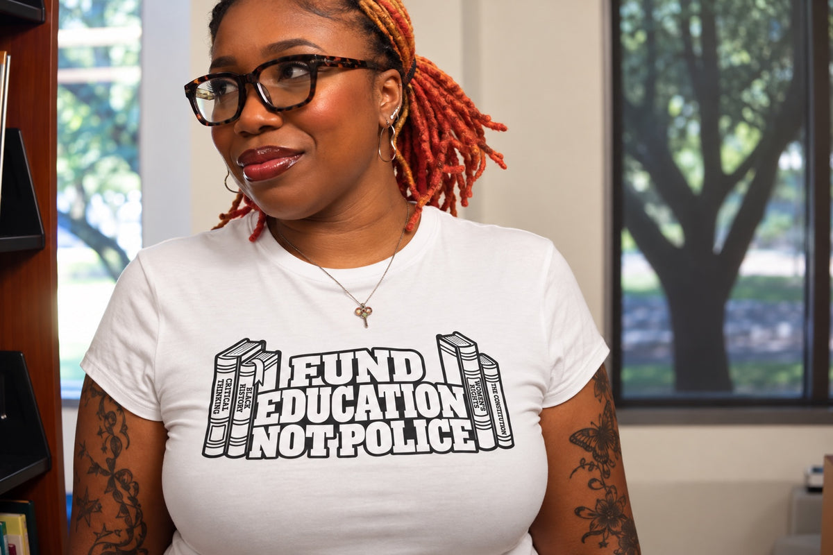 Model wearing Fund Education Not Police graphic tee with black-and-white books design